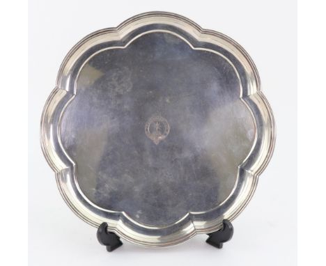 A George I style lobed circular silver salver, Mappin & Webb, Sheffield 1927, with moulded edge, on four feet, engraved to th