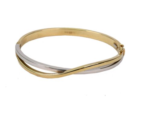 A modern Italian white and yellow gold cross-over bangle, stamped '375', 8g.