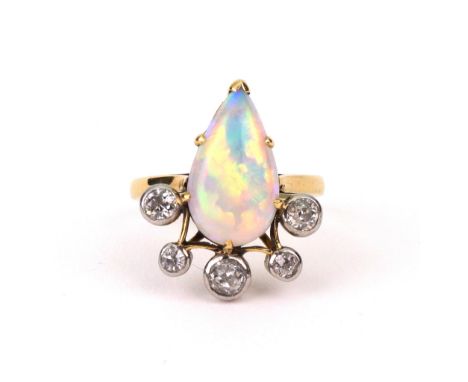 A cabochon white opal and five-stone diamond ring, the tear shaped opal with five rub-over set old-cut diamonds, marked indis