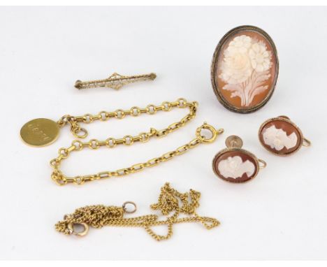 A small collection of jewellery, comprising; an early 20th century gold bracelet, stamped '9c'; hung with a later disc pendan