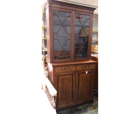 A 'Sheraton' Revival mahogany satinwood crossbanded bookcase cabinet, boxwood and ebony strung, enclosed by a pair of glazed 