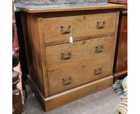 An Edwardian oak chest, patent no. 8896-1904, with three long drawers, on a plinth base, 84cm wide.