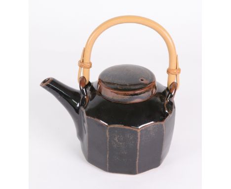 David Leach (1911 - 2005), Lowerdown Pottery teapot and cover, with panelled sides, in tenmoku glaze, bamboo handle, impresse