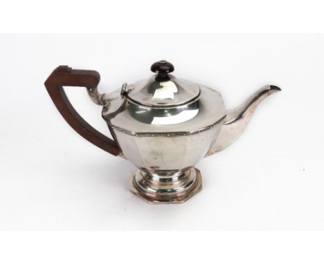 An Art Deco silver teapot, E W Haywood, Birmingham 1945, of panelled tapering form with a beaded interlaced scroll upper frie