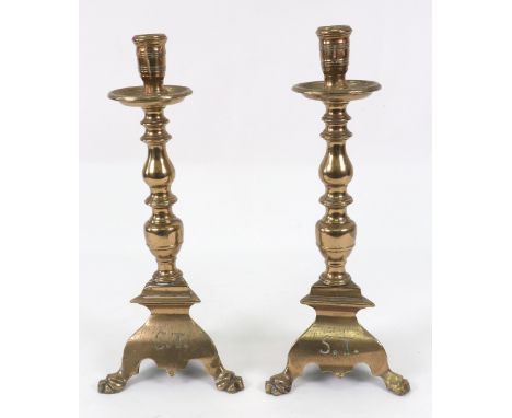 A pair of Italian brass pricket type altar candlesticks, the baluster and ring turned stems on spreading triangular bases of 