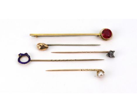 A 9ct gold and pink tourmaline stick pin, a fox mask stick pin set with rose-cut diamonds, a 'gold nugget' stick pin, a cultu