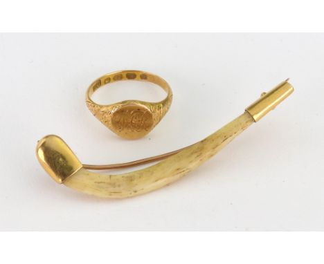 An 18ct yellow gold signet ring, engraved initials and spiral engraved shoulders, Birmingham 1866, 3.9g and a gold mounted cl