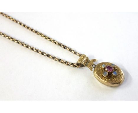 A late Victorian floral engraved gold, small water-opal and ruby five stone locket, later adapted as a pendant, and hung from