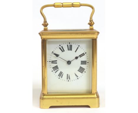 A brass cased carriage clock, early 20th century, the white enamel dial with Roman numerals, striking on a gong, in an obis c