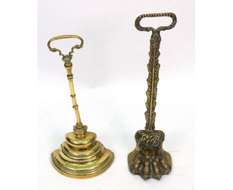 A brass claw door porter or door stop, 19th century, with gadrooned handle, 39cm high, and another with ring turned stem and 