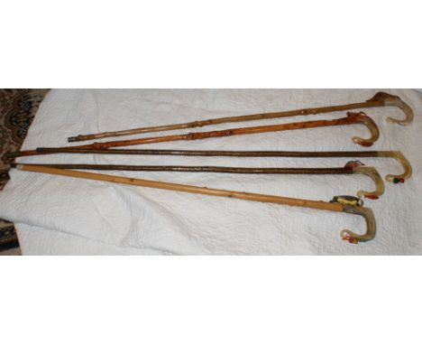 Five horn-handled shepherd's crooks carved with woodpecker, ferret, deer, kingfisher, scotch thistle
