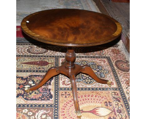 Good quality mahogany circular tripod coffee table on four brass paw feet with casters. Chapmans, Newcastle