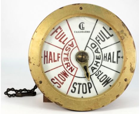 A bulkhead engine room telegraph by Chadburn's, London:, the 9 inch enamelled indicator under brass bevel, pullies and chain 