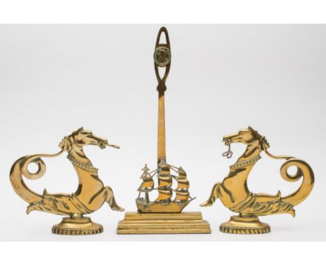 A brass doorstop with a circular portrait of Admiral Nelson over a model of HMS Victory, together with a pair of brass Veneti