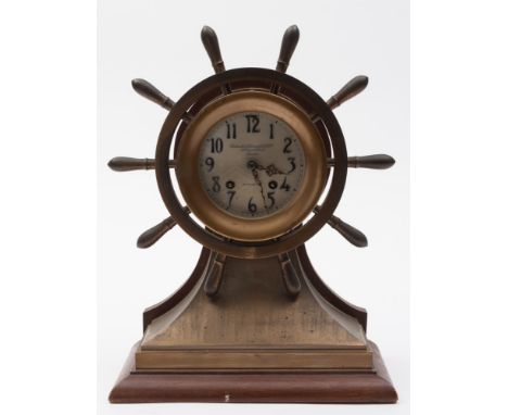 An Edwardian gilt ship's helm mantel clock presented as a gift by The Earl of Jellicoe to Dr P H Devitt, together with signed