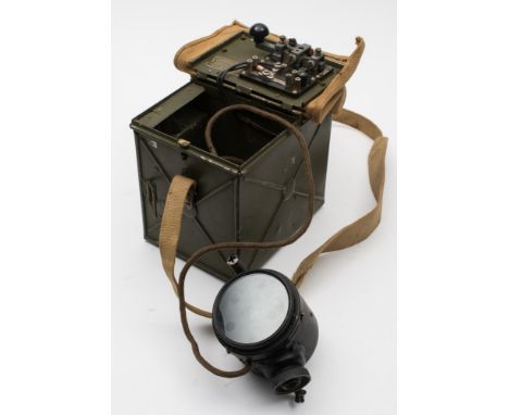 A WWII period daylight short range signal lamp:, in a green case with lamp and morse key with canvas strap.