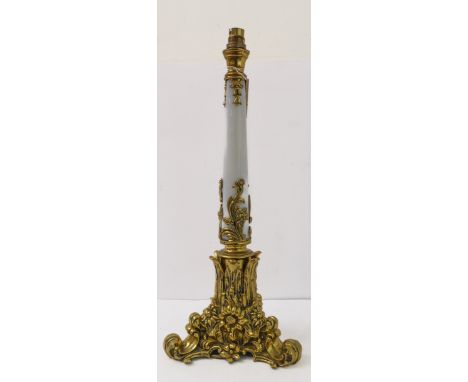 A large and heavy early 20th century polished brass table-lamp (fitted for electricity): tapering opaque glass stem, triform 