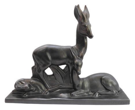 A large ceramic model of a stag, doe and fawn in&nbsp;Art Deco style:&nbsp;matt-black glaze,&nbsp;the plinth base with impres