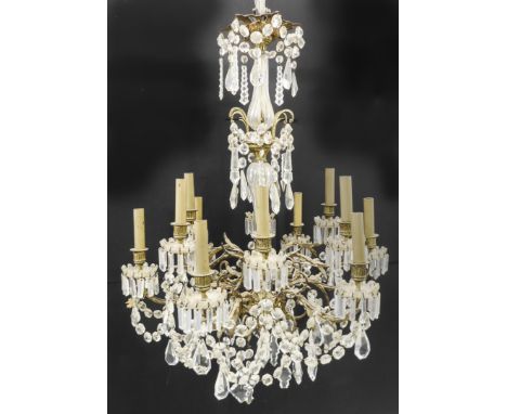 A large and showy 12-light, gilt-metal and faceted-glass chandelier with various sized and shaped droplets (requires cleaning