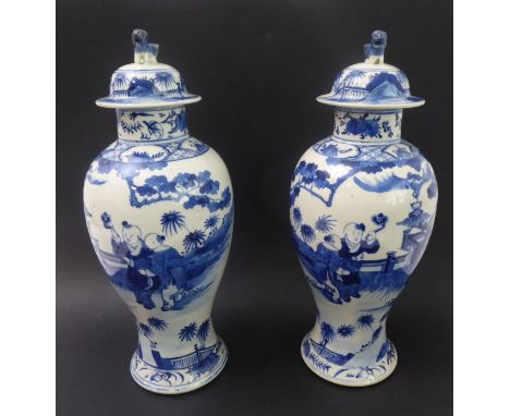 A pair of 19th century Chinese baluster-shaped porcelain vases and covers: each dome-topped cover surmounted with a stylised 