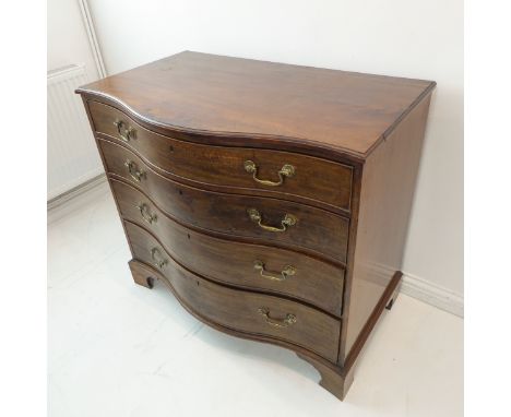 A late 18th century serpentine fronted mahogany commode: moulded top above four full-width graduated drawers (probably with o