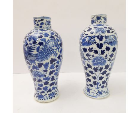 A pair of 19th century Chinese baluster-shaped porcelain vases, each hand-decorated in underglaze cobalt blue, the first with