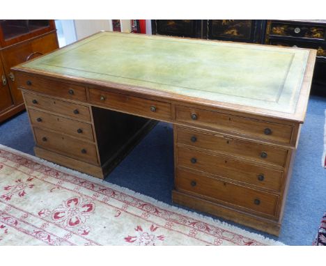 A large 19th century mahogany partners' desk: the gilt-tooled, light-green leather inset moulded top with three frieze drawer