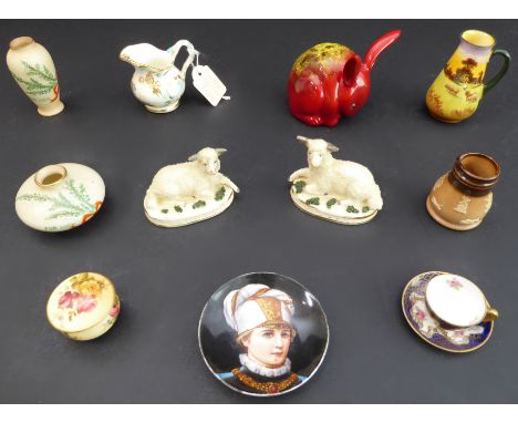 Eleven miniature ceramics to include:a pair of 19th century Staffordshire-style recumbent lambs (16.5 cm wide);a Royal Doulto