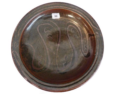 A large Winchcombe pottery dish decorated in a swirling lusterware style design, impressed mark to underside (34cm diameter)&