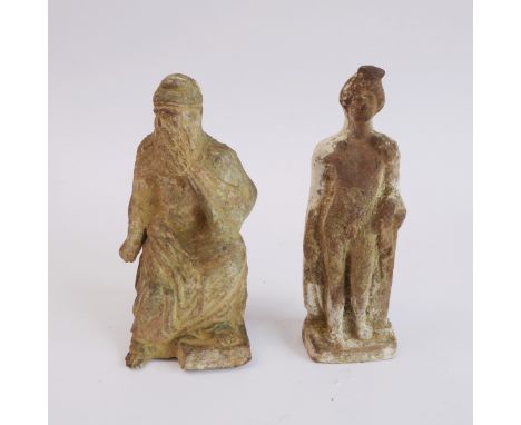 An early terracotta standing figure: nude male with his left arm resting upon a pedestal, probably Roman, hollow and with ver