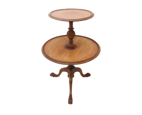 A Georgian-style two-tier circular mahogany&nbsp;étagère: the smaller dished top above turned stem and on tripod base termina