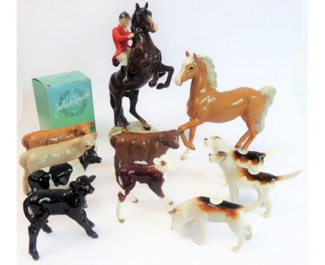 Eleven pieces by Beswick:huntsman on a rearing horse (868);three foxhounds (one boxed), palomino horse;six calves to include 