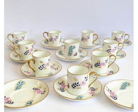 A set of ten 19th century coffee cans, hand-gilded and decorated with floral sprigs, together will twelve matching saucersCon
