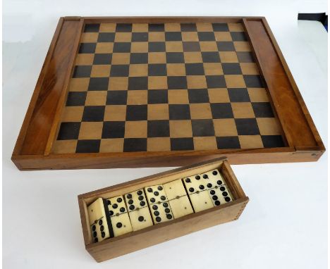 A late 19th/early 20th century walnut-framed chess/draughts board (43cm x 35cm): the two ends with slides opening to reveal n