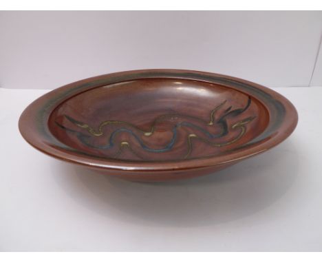 Ray Finch (Winchcombe Pottery, Gloucestershire),&nbsp;charger; glaze trailed meander decoration through rust slip (34cm diame