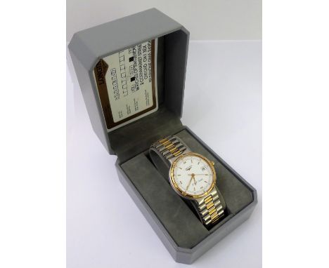 A gentleman's cased Longines' Conquest' steel and gold-plated, mounted dress wristwatch: the white dial signed and with baton