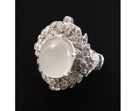 An attractive moonstone and diamond-set ring: the oval moonstone within a floral and foliate diamond-set garland surround to 