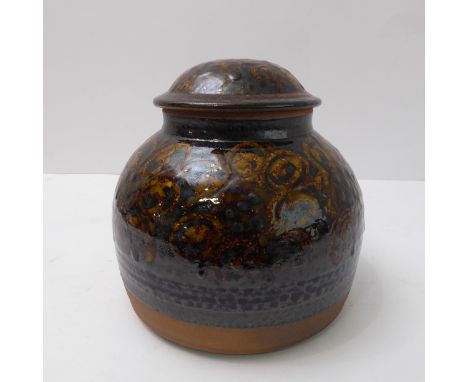 Peter Dick (Winchcombe Pottery&nbsp;and Coxwold Pottery), lidden jar; white slip decoration under iron rich slip glaze (18cm 