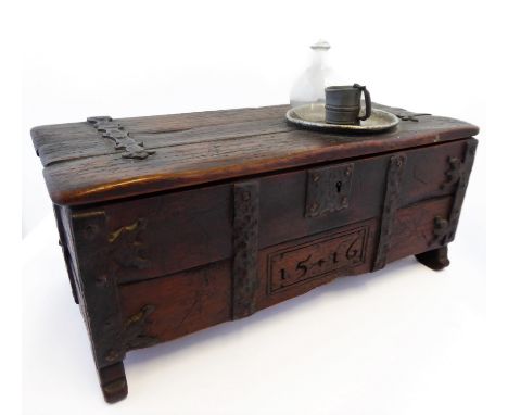 A patinated and iron-mounted miniature reproduction oak chest in early style: the lid with strap hinges, a pewter plate and t