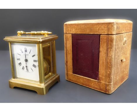 A late 19th to early 20th century brass and glass-sided carriage clock of small proportions: the white enamel dial with Roman