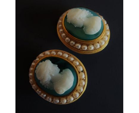 A pair of hardstone cameo and half pearl ear clips: each containing a green agate with a carved white agate head and shoulder