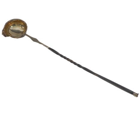 A Georgian white-metal toddy ladle (late 18th / early 19th century): twisted whalebone handle and bright-cut decoration and e