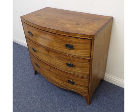 An early 19th century bow-fronted, caddy-topped mahogany chest of pleasing proportions: three full-width graduated drawers, s