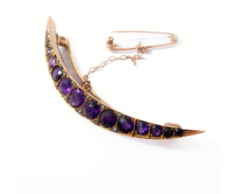 A late 19th/early 20th century amethyst and half pearl crescent brooch: the graduated line of mixed-cut amethysts with half p
