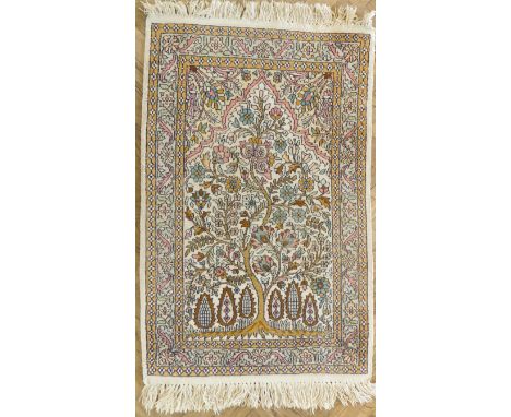 A Kashmir prayer rug: Tree of Life on a cream ground, the light green varying sized borders with leaves and scrolls (97cm x 6