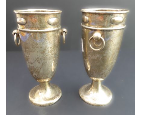 A pair of hallmarked-silver pedestal vases: each with two-ring handles and on circular spreading foot, hallmarks rubbed (16.2