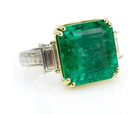 Approx. 12.2 Carat Colombian Emerald and 18 Karat White and Yellow Gold Ring accented with 1.10 Carat Baguette Diamonds. Emer