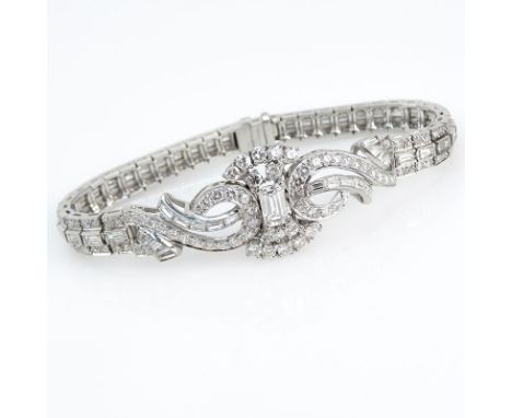 Art Deco Approx. 10.80 Carat TW Diamond and Platinum Bracelet. Set in the Center with an approx. .80 Carat Emerald Cut Diamon
