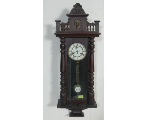 A small early 20th century Venetian style mahogany cased 8 day wall hanging clock having ceramic dial with Roman numerals to 