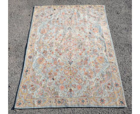 Embroidered tapestry wall panel with central floral medallion and all over scrolling floral design on a light blue ground, 17